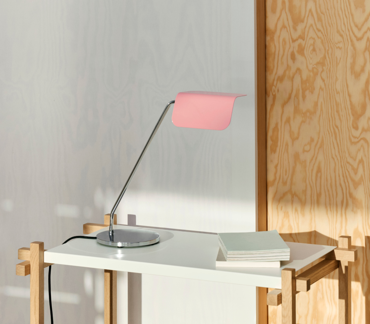 Lámpara Apex de diseño en color rosa sobre una mesa